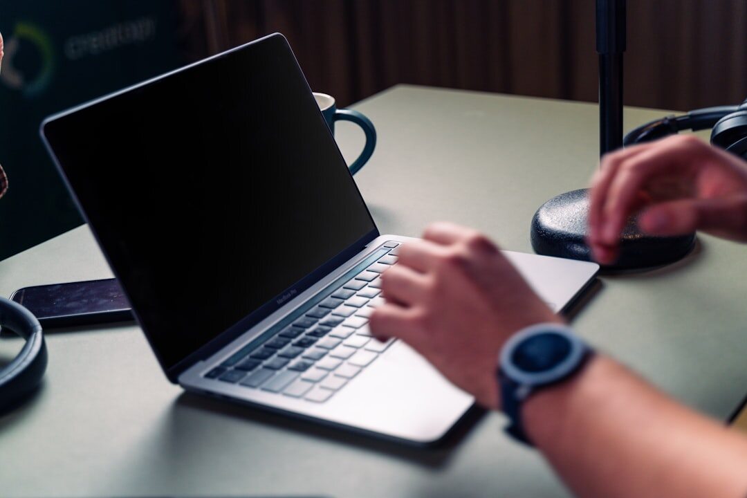 person writing on laptop