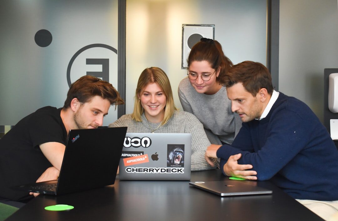 team collaborating on laptop in office